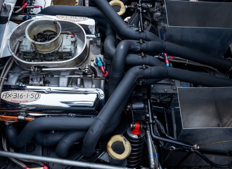 Close-up of Ford GT40 MKII engine bay showing experimental AX-316-1-50 stamps on chrome valve covers.