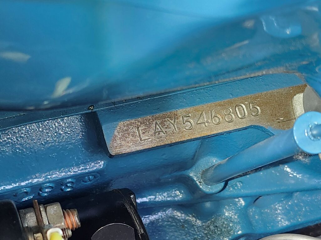 A close-up of a 1953 Corvette engine serial number used to verify if a vehicle is numbers matching during an appraisal.