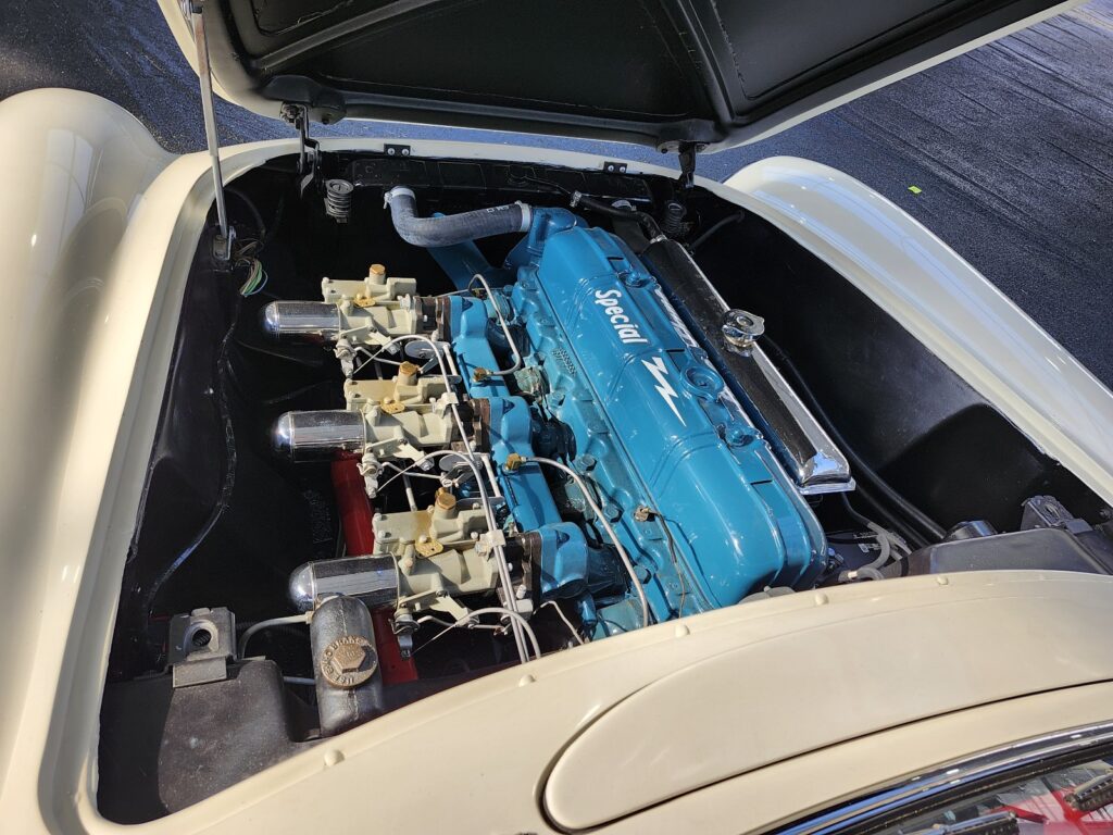 The iconic triple side-draft carburetor setup on a 235 CI Blue Flame inline 6-cylinder Corvette engine.