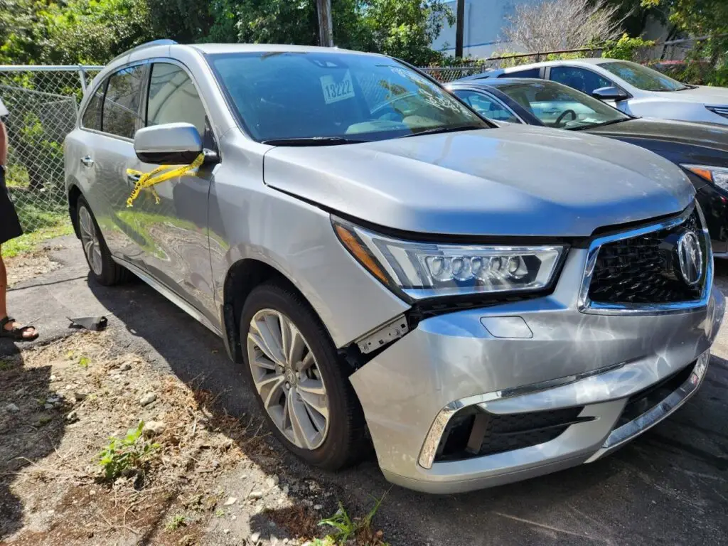 Front-end impact and bumper misalignment on a silver Acura MDX being inspected for a diminished value appraisal in Hialeah Florida.