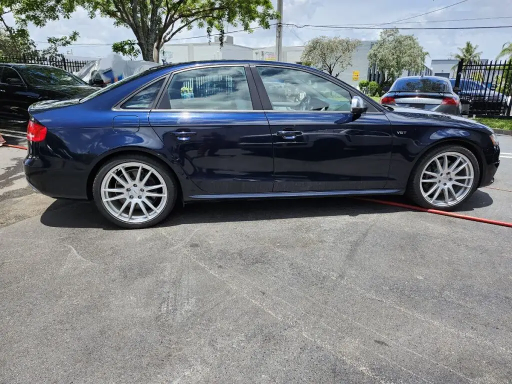Side-profile valuation of a dark blue Audi S4 performance sedan for a certified diminished value appraisal in Hialeah.
