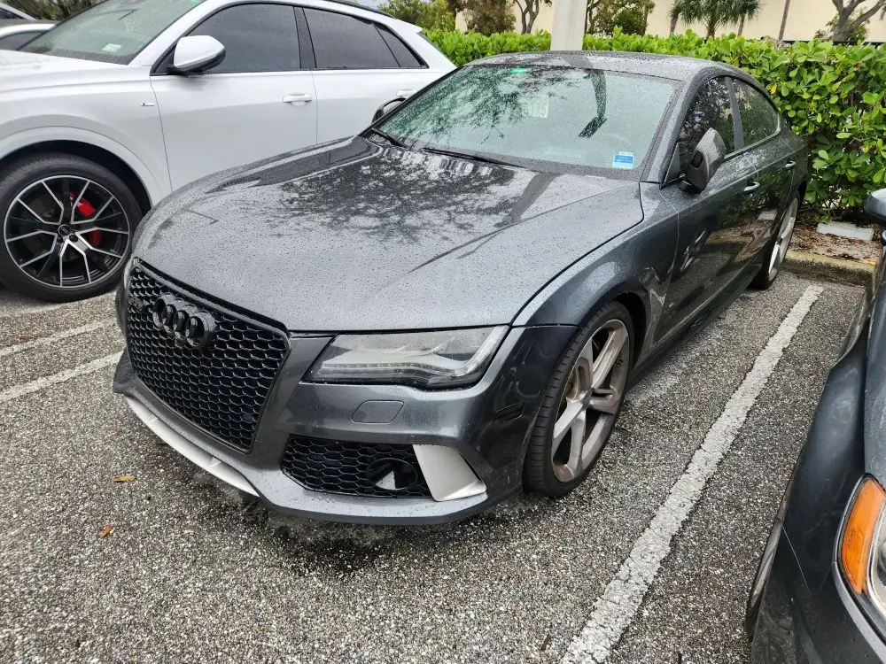 Front-angle damage evaluation of a charcoal grey Audi RS7 for a professional diminished value appraisal Jupiter Florida.