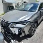 Documenting significant front-end collision damage on a grey Lexus NX 300 for a diminished value appraisal in Boynton Beach.