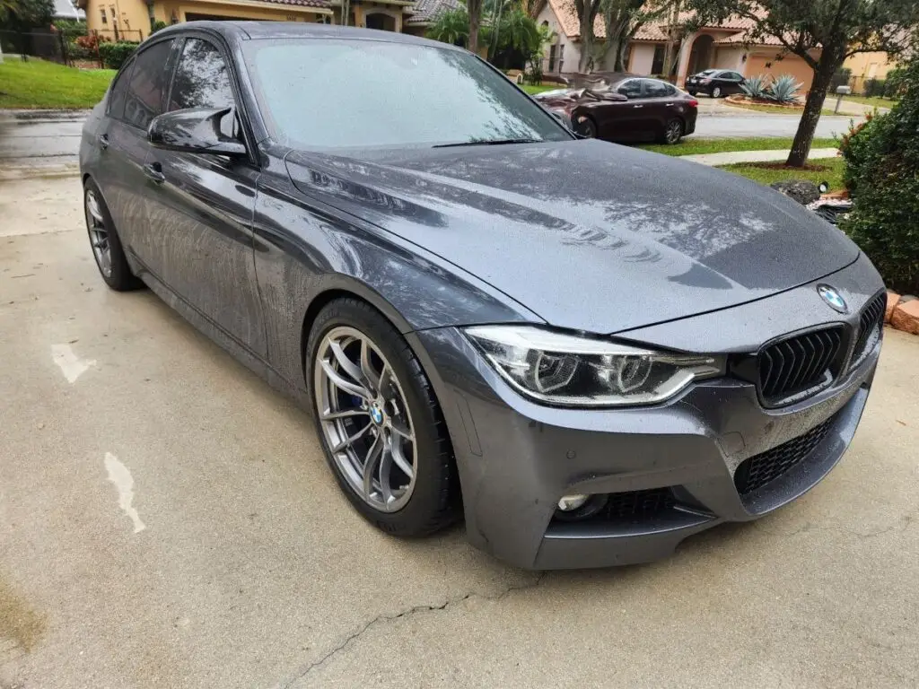 Side-profile market assessment of a grey BMW 3 Series to determine the inherent loss for a diminished value appraisal in Coral Springs Florida.