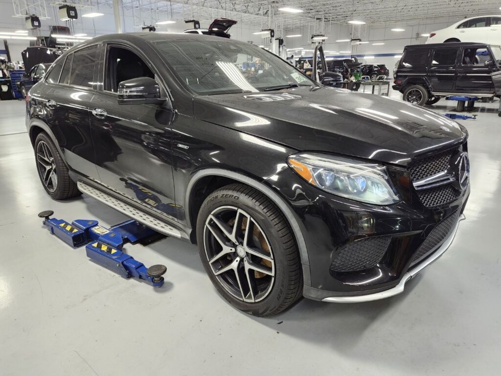 Assessing side-impact and structural repairs on a black Mercedes-Benz GLE 450 Coupe for a diminished value appraisal in Coral Springs Florida.