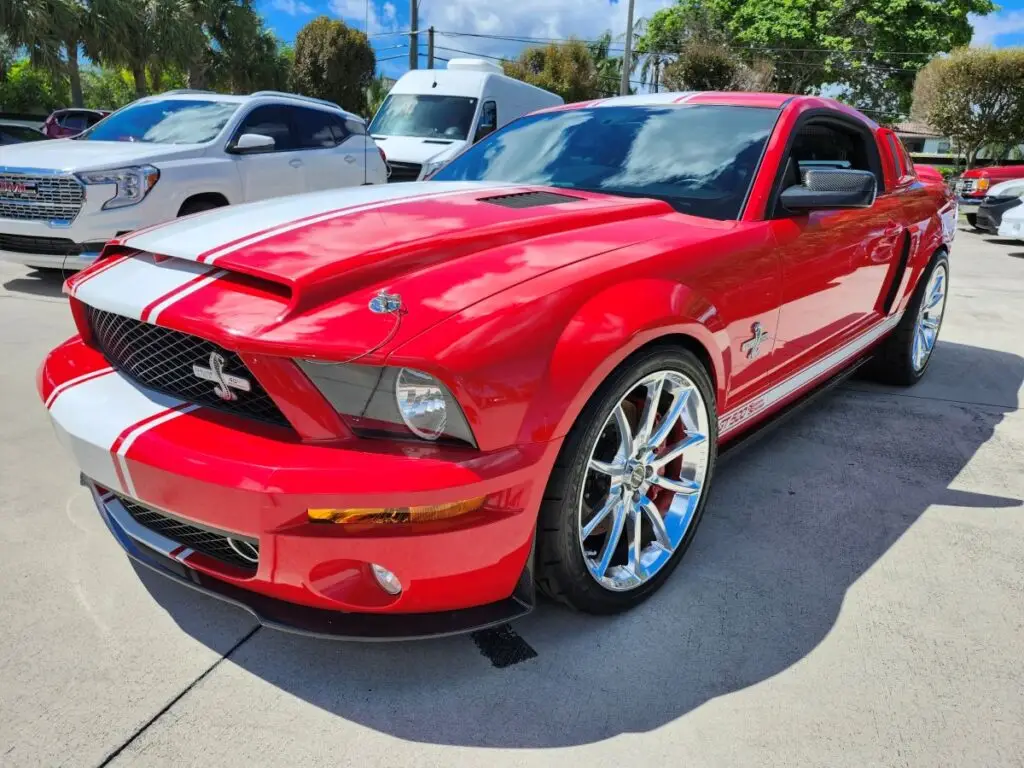 Front-angle market assessment of a red 2008 Ford Mustang Shelby GT500 Super Snake for a specialized diminished value appraisal Daytona Florida.