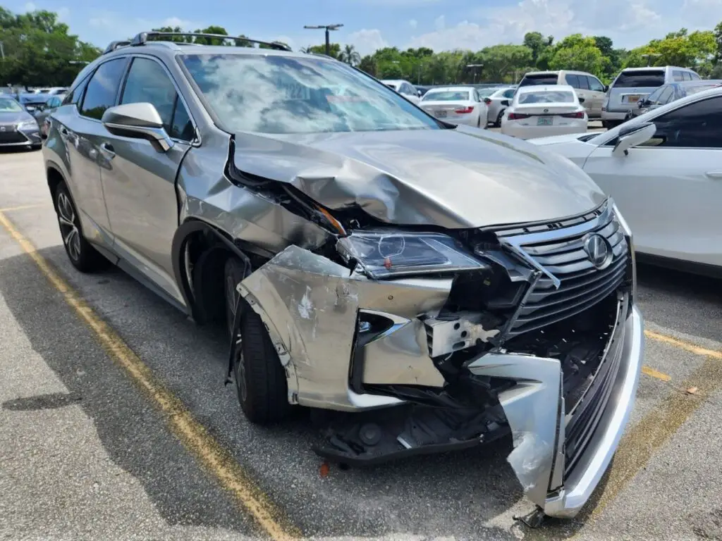 Documenting significant front-end collision damage on a silver 2019 Lexus RX 350 for a diminished value appraisal in Deerfield Beach Florida.