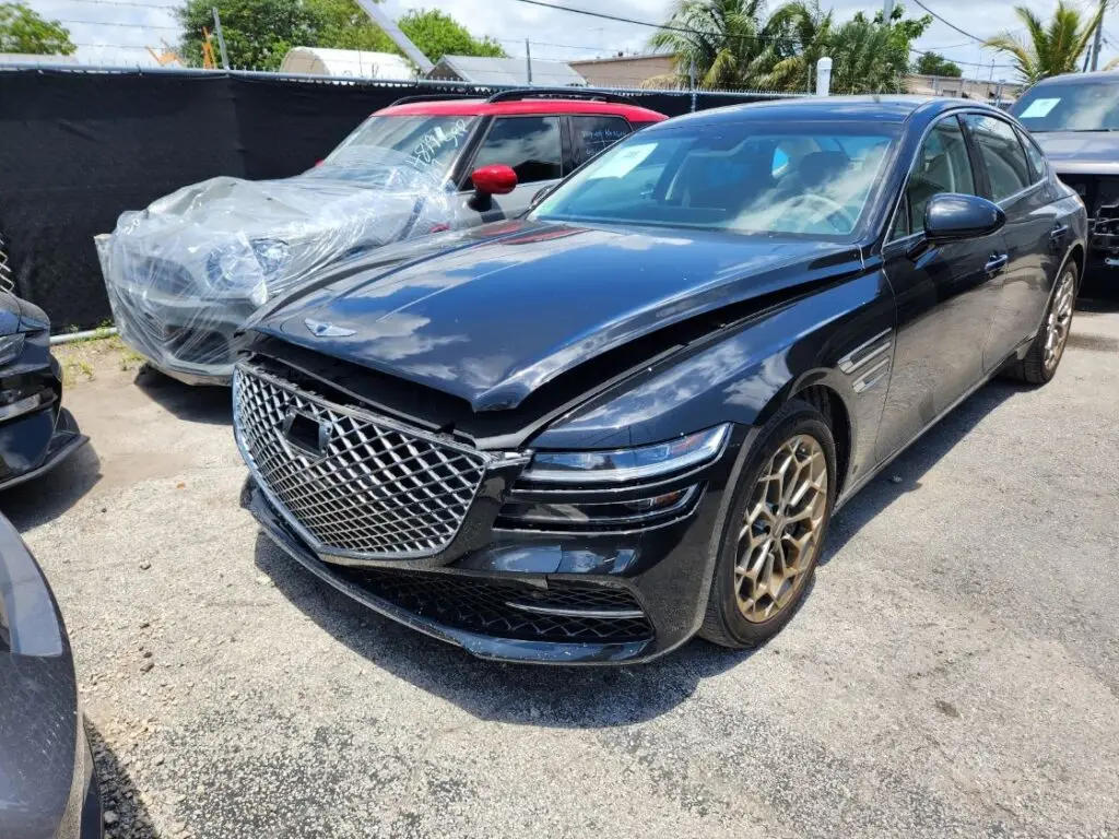 Assessing front-end collision impact on a black Genesis G80 for a diminished value appraisal in Delray Beach Florida.