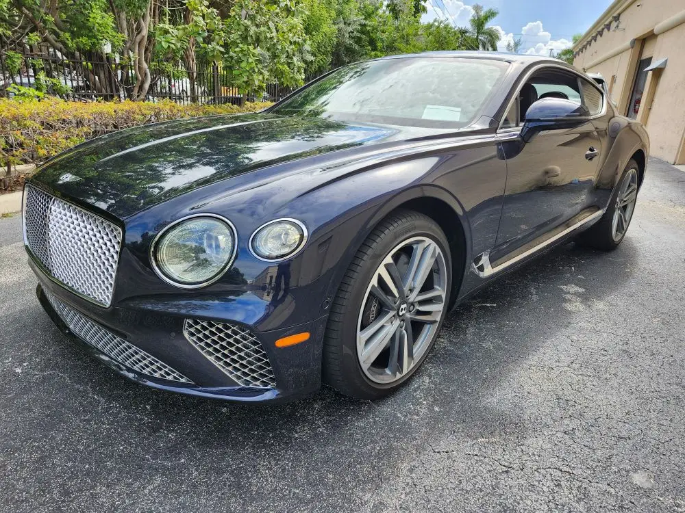 Front-view market assessment of a dark blue 2021 Bentley Continental GT for a specialized diminished value appraisal Fort Myers Florida.