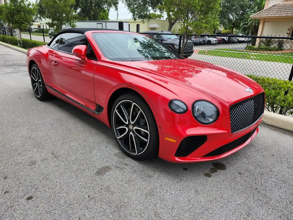 Front-angle market assessment of a red 2022 Bentley Continental GT convertible for a specialized diminished value appraisal Jacksonville Florida.