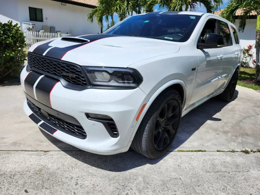 Front-angle valuation of a white 2021 Dodge Durango SRT 392 with racing stripes for a certified diminished value appraisal Jacksonville Florida.