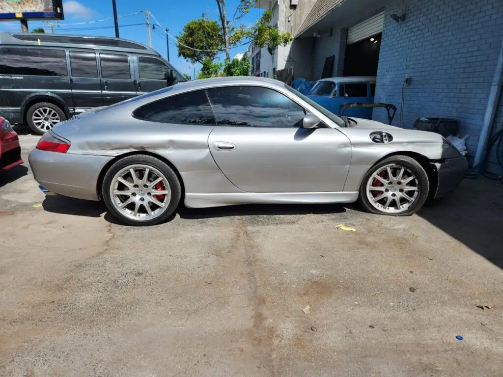 Documenting the market impact of side-impact repairs on a silver Porsche 911 Carrera for a diminished value appraisal Jacksonville.