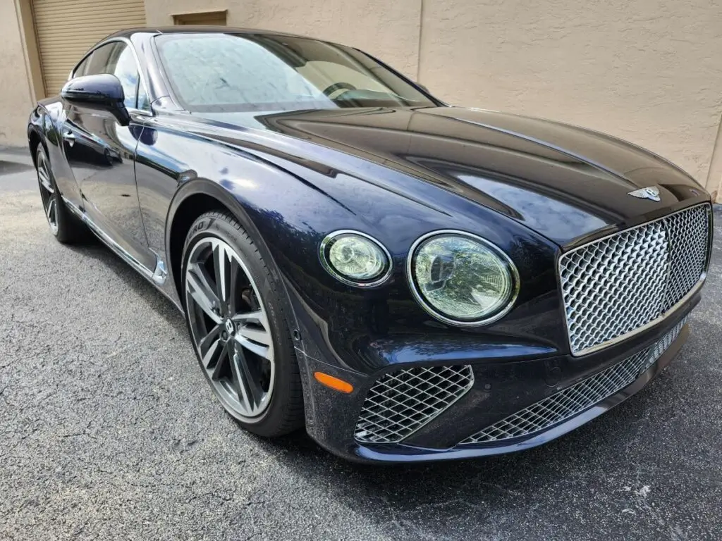 Front-angle market assessment of a dark blue 2024 Bentley Continental GT to support a specialized diminished value appraisal in Miami Gardens Florida.