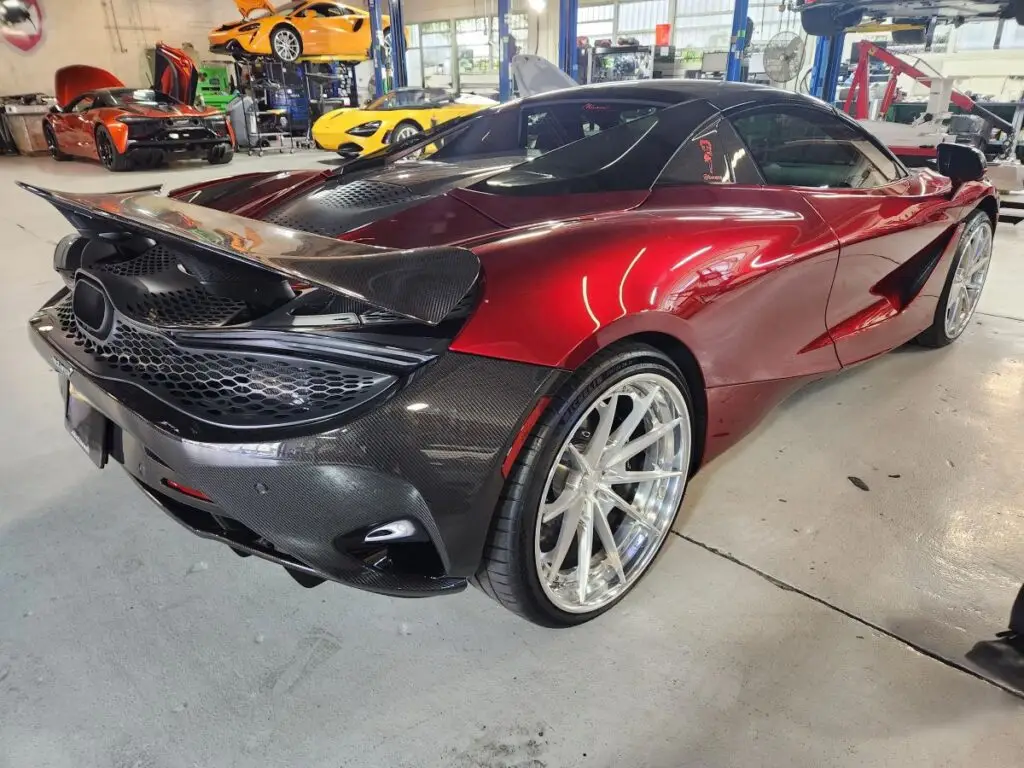 Documenting the market impact of front-end collision repairs on a red 2022 McLaren 720S for a diminished value appraisal in Miami Gardens.
