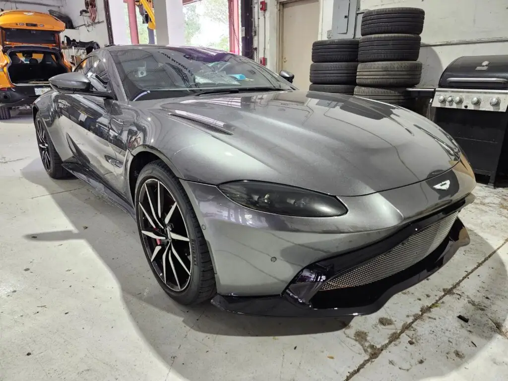 Front-angle market assessment of a grey 2020 Aston Martin Vantage for a specialized diminished value appraisal Naples Florida.