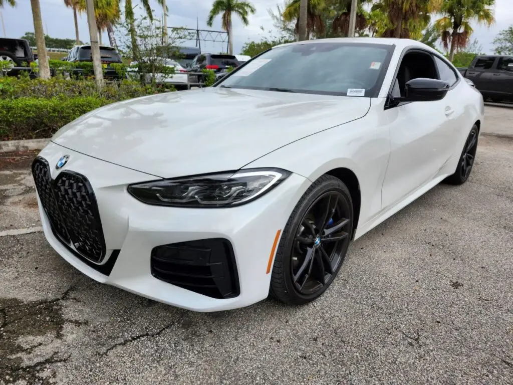Front-angle market assessment of a white 2021 BMW 440i coupe for a specialized diminished value appraisal Orlando Florida.
