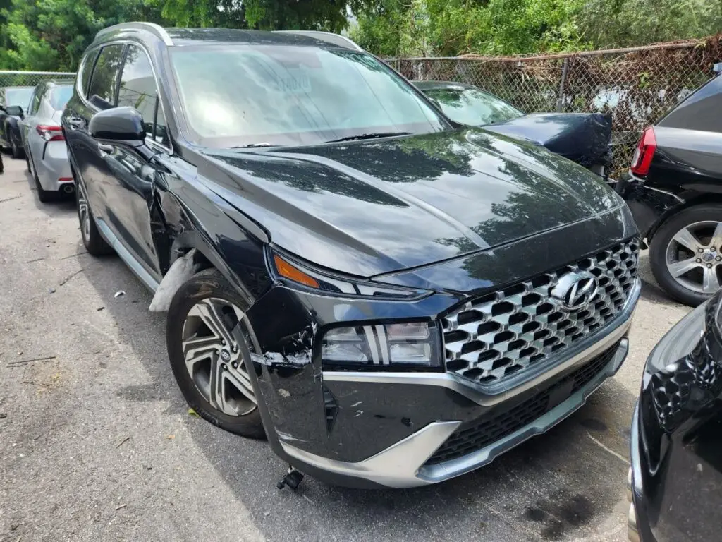 Assessing side-impact and structural repairs on a black 2022 Hyundai Santa Fe for a diminished value appraisal Orlando Florida.