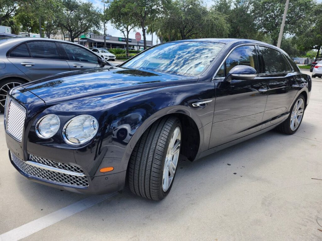 Side-view market assessment of a dark blue 2017 Bentley Flying Spur for a specialized diminished value appraisal in Palm Beach Gardens Florida.