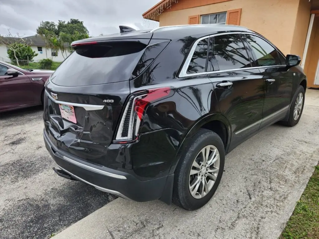 Assessing rear-end liftgate damage on a black Cadillac XT5 to document the inherent loss for a professional diminished value appraisal in Plantation Florida.