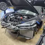 Documenting the market impact of front-end collision repairs on a black 2023 Chevrolet Corvette C8 for a diminished value appraisal in Pompano Beach.