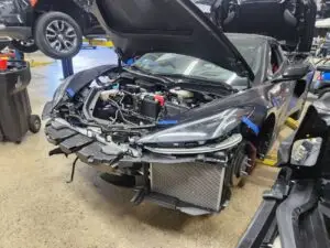 Documenting the market impact of front-end collision repairs on a black 2023 Chevrolet Corvette C8 for a diminished value appraisal in Pompano Beach.