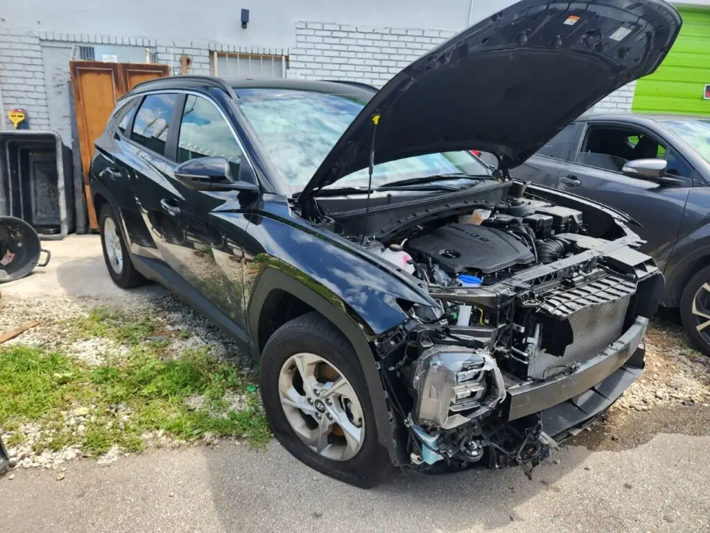 Assessing significant front-end collision and engine bay repairs on a black 2022 Hyundai Tucson for a diminished value appraisal Tallahassee Florida.