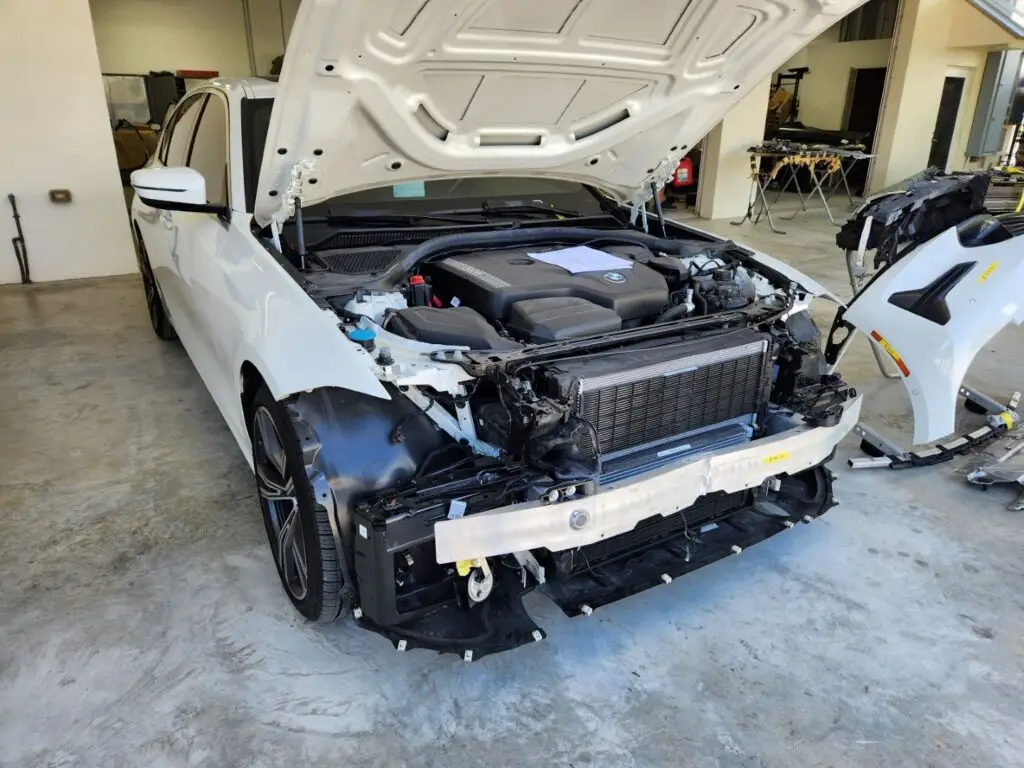 Documenting significant front-end collision and structural repairs on a white 2020 BMW 330i for a diminished value appraisal Tampa Florida.