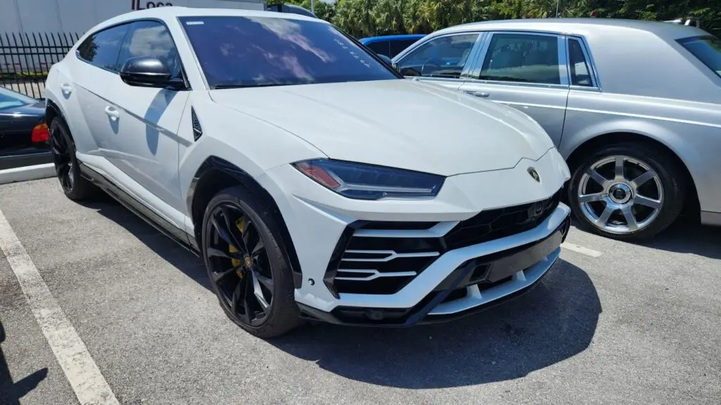 Front-angle market assessment of a white Lamborghini Urus to support a certified diminished value appraisal in Parkland.