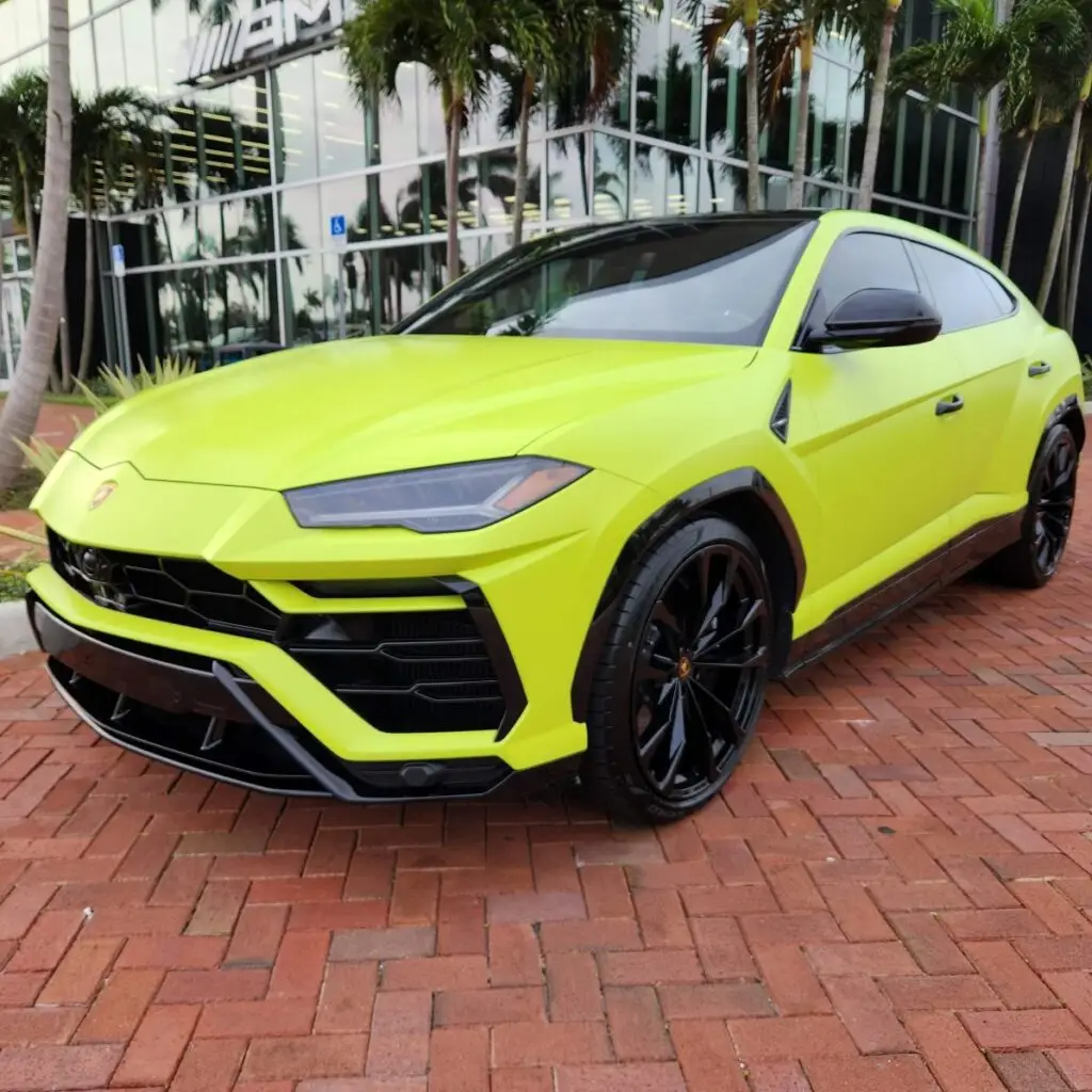 Matte yellow Lamborghini Urus SUV parked at a dealership for a high-end diminished value appraisal service in the Palm Beach exotic car market.