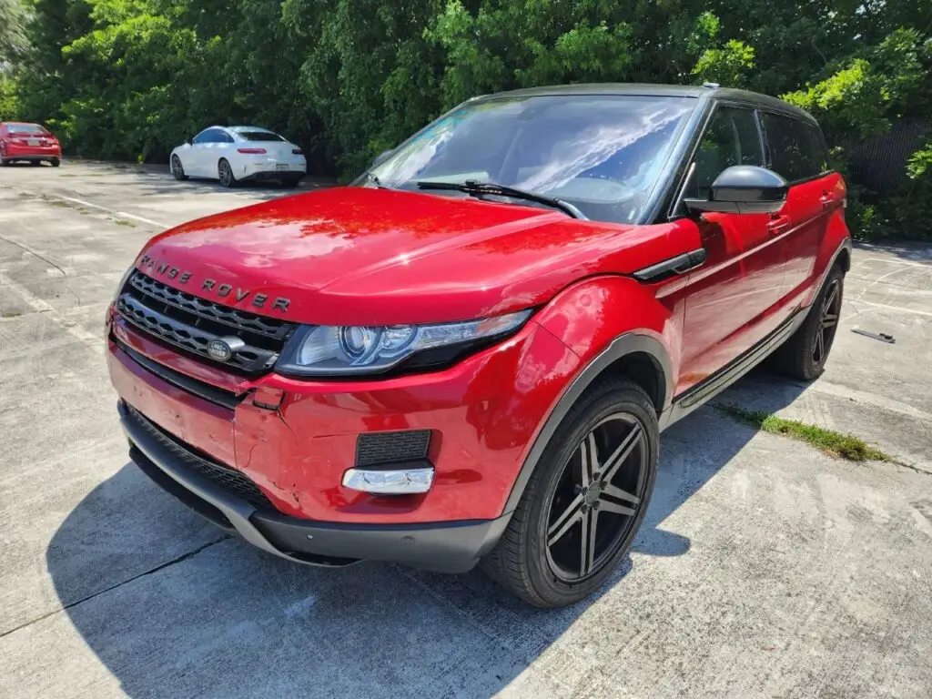 Front-end collision damage audit on a red Land Rover Range Rover Evoque for a diminished value appraisal in Hialeah Florida.