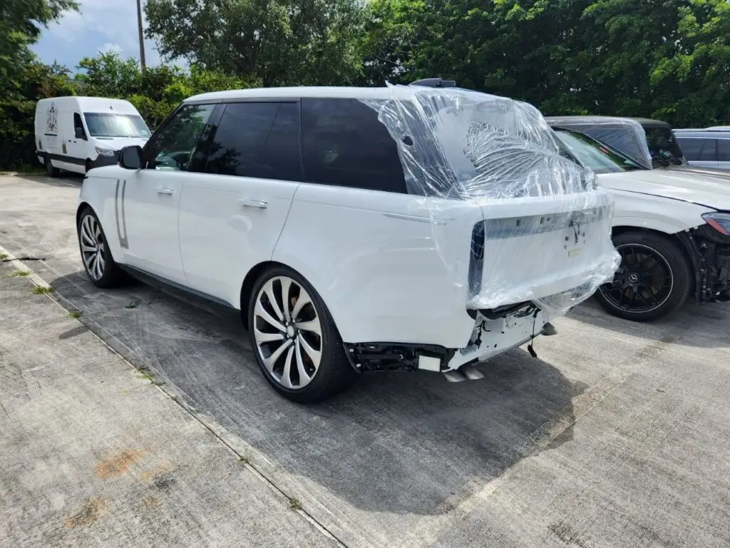 Rear-end structural assessment of a white 2023 Land Rover Range Rover for a certified diminished value appraisal in Jupiter.