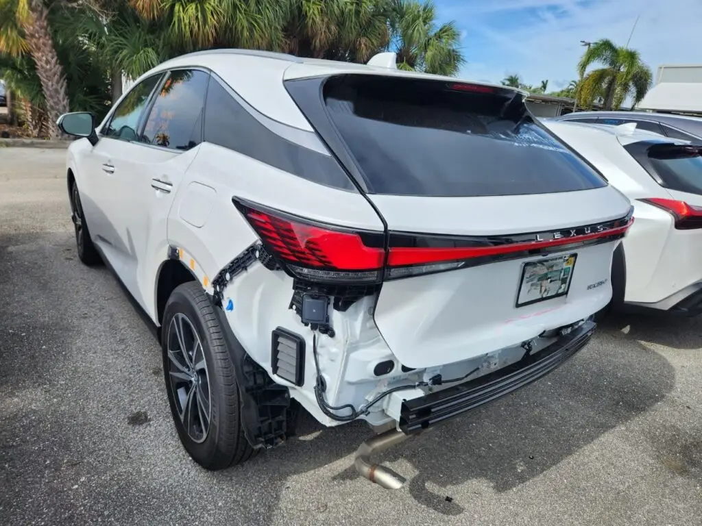 Documenting rear-end bumper and sensor damage on a white Lexus NX 350 for a diminished value appraisal in Hollywood Florida.