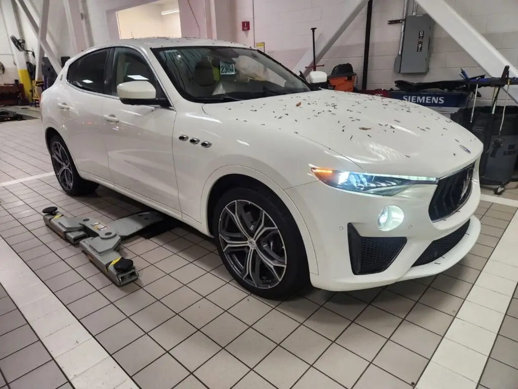 A Maserati Levante on a lift in a Boca Raton service center for a post-repair inspection to verify the quality of work and assess diminished value.