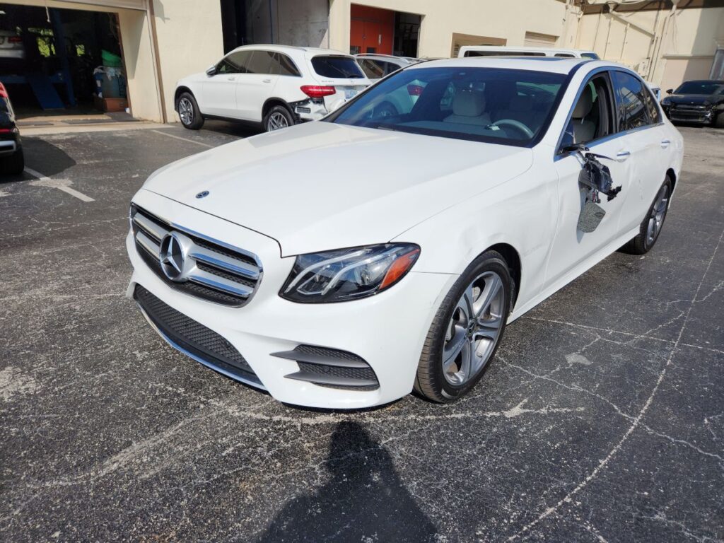 Documenting driver-side mirror and door damage on a white 2021 Mercedes-Benz E-Class for a diminished value appraisal Lake Worth.