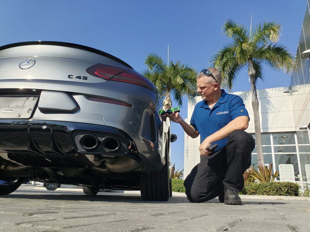 Certified appraiser inspecting a 2018 Mercedes-Benz C43 AMG for a diminished value appraisal in Royal Palm Beach Florida.