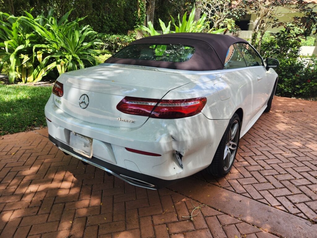 White Mercedes-Benz with right rear quarter panel and bumper damage used as a case example for calculating car value loss after accident and inherent diminished value.