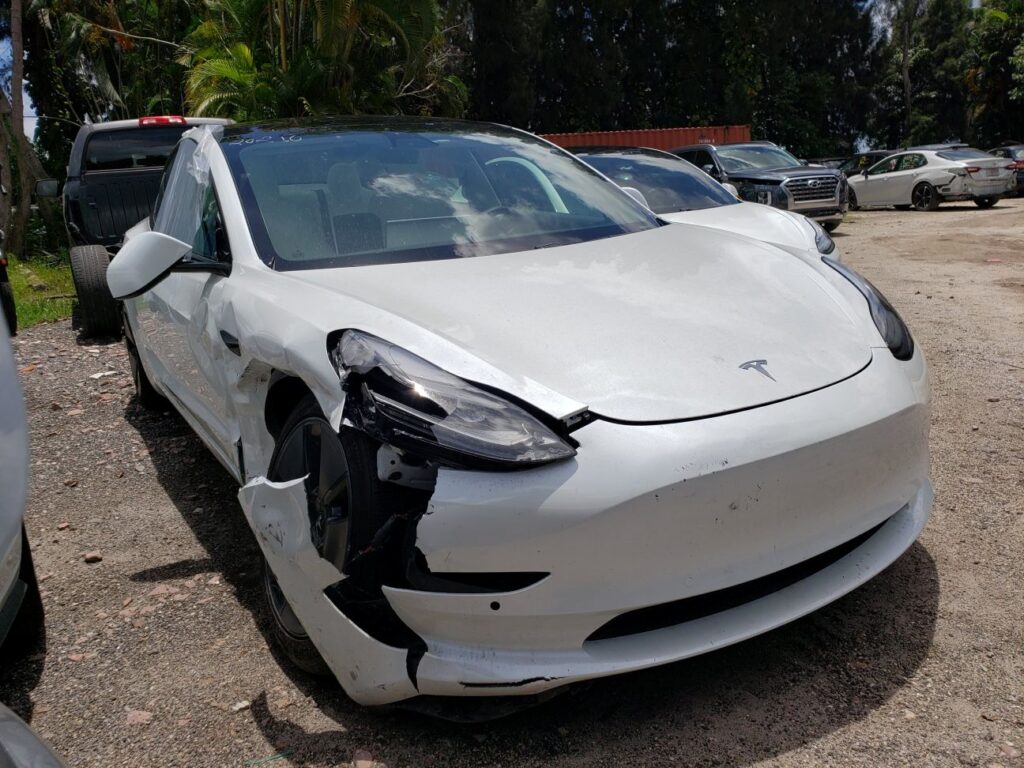 Damaged white Tesla Model 3 in Lake Worth showing rear bumper and liftgate impact, used to illustrate the Florida diminished value claim process.