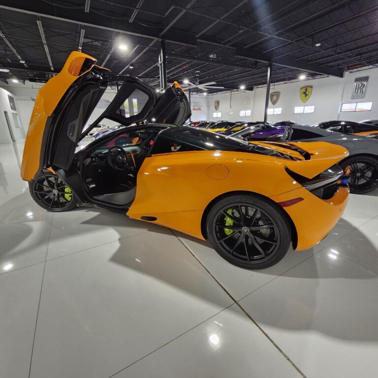 A detailed inspection of the multi-stage factory paint on a 2018 McLaren 720S during a specialized paint valuation in Naples, Florida, to document diminished value.
