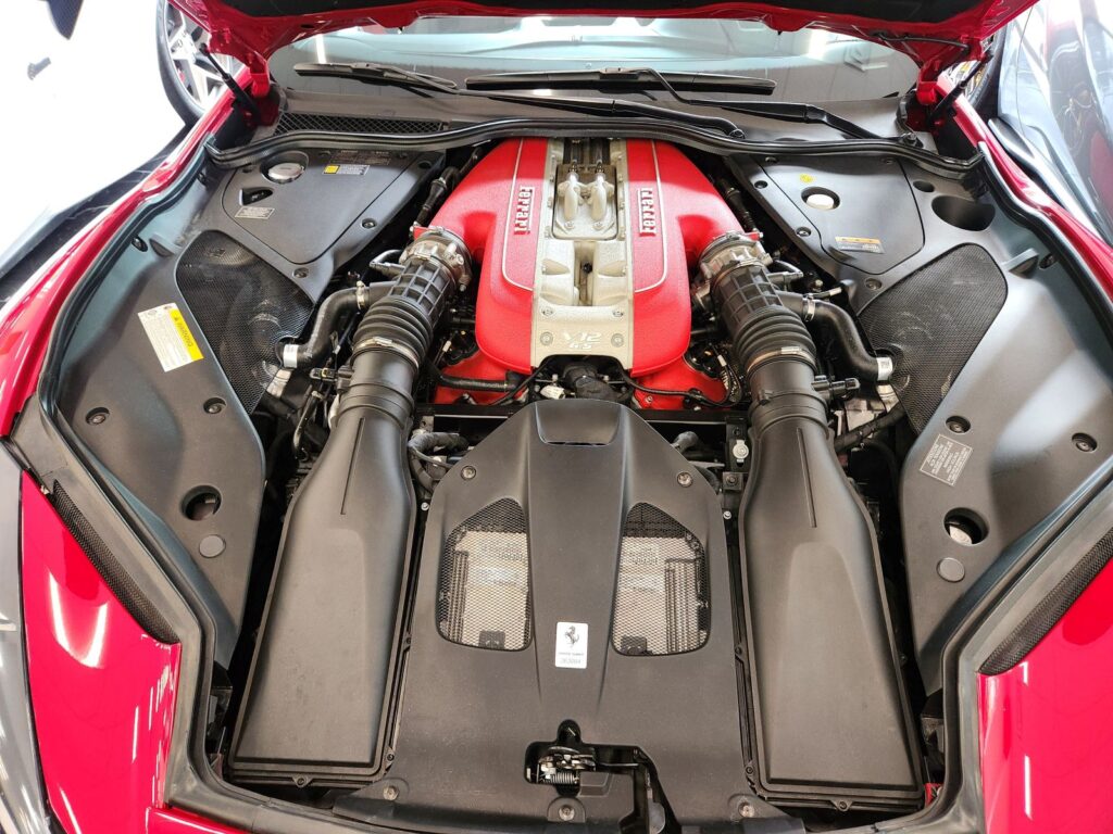 Ferrari V12 engine bay showing OEM components critical to high-end vehicle resale value