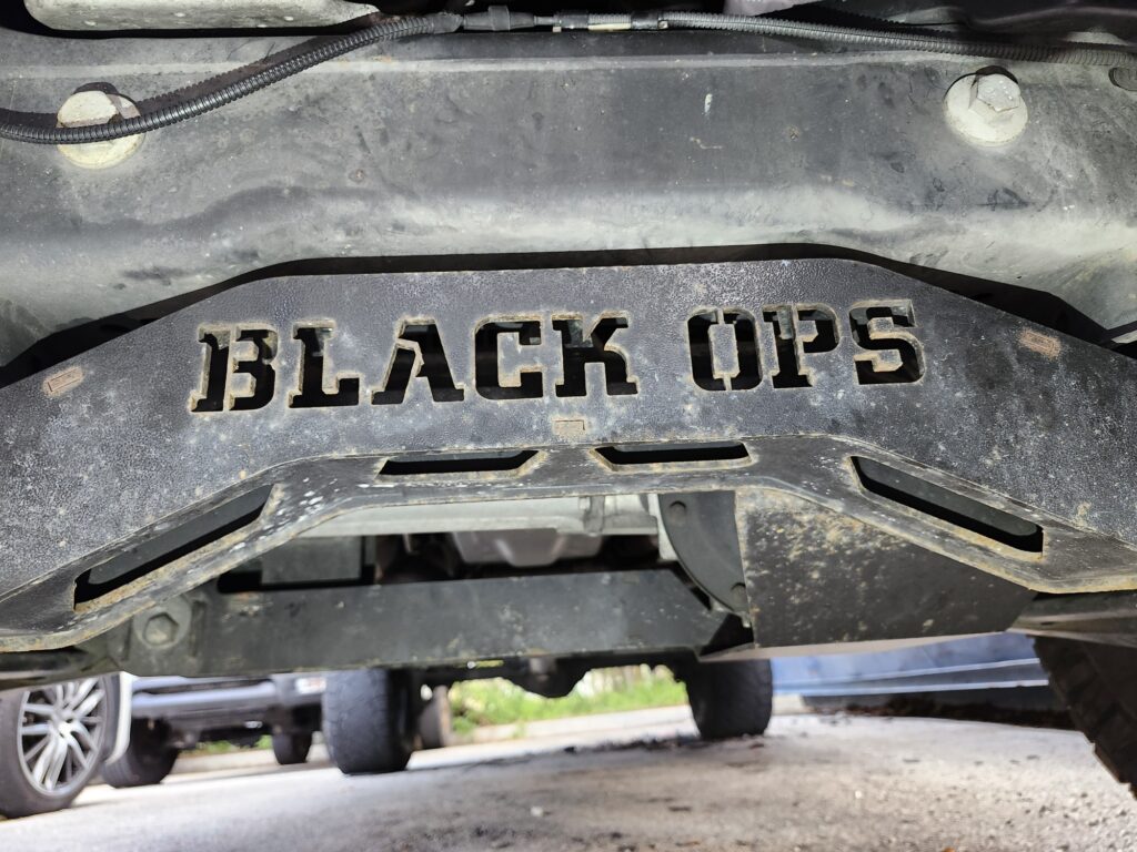 Black Ops suspension lift component on a Ford F150 Black Ops Edition inspected for total loss valuation analysis in Florida