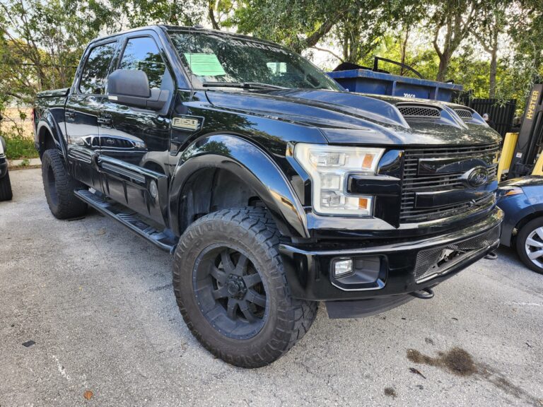 2016 Ford F150 Black Ops Edition truck photographed during a total loss appraisal inspection in West Palm Beach FL