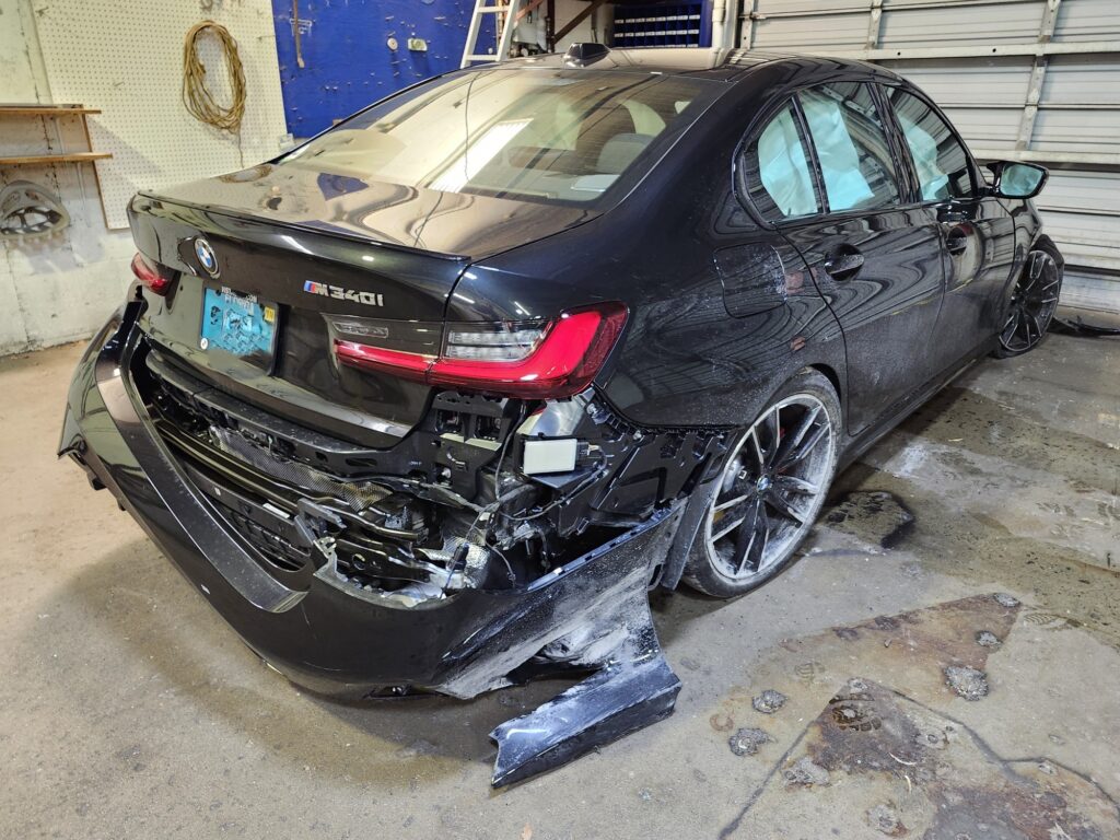 BMW M340i with rear structural damage and bumper removed after collision