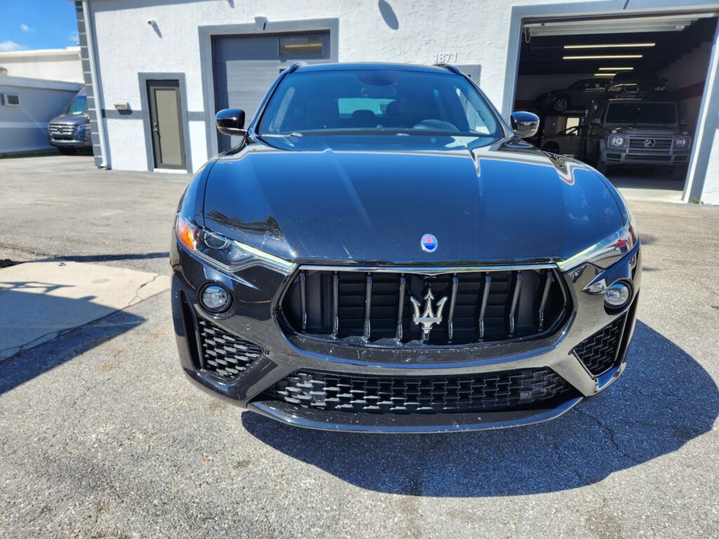 Maserati SUV front end inspected by independent car appraiser for aftermarket part quality