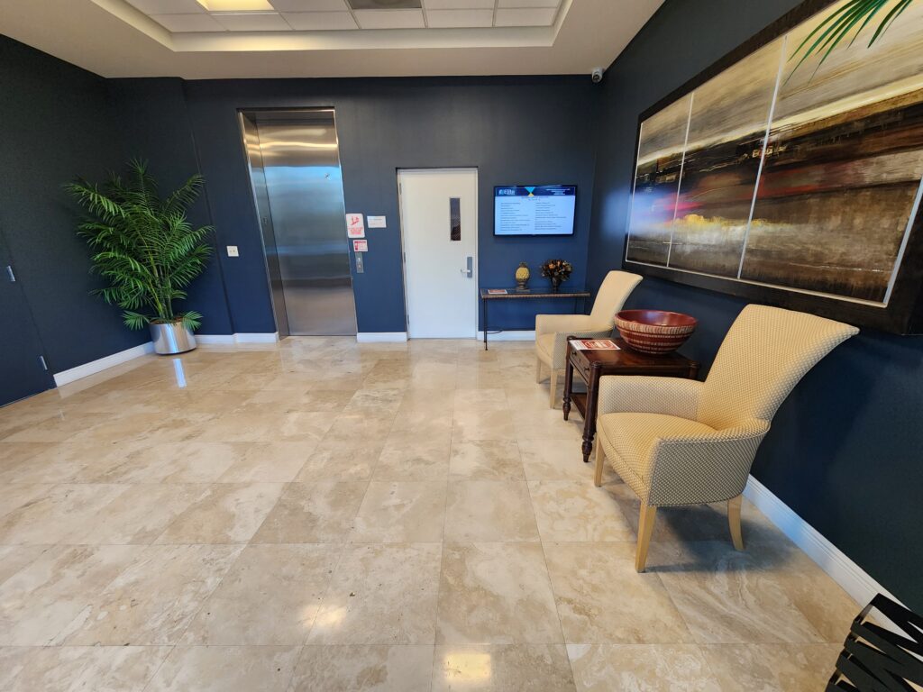 Interior lobby of Elite Office Suites at 6810 N State Road 7, Suite 332, Coconut Creek, FL — home of Auto Praise Vehicle Evaluation Services