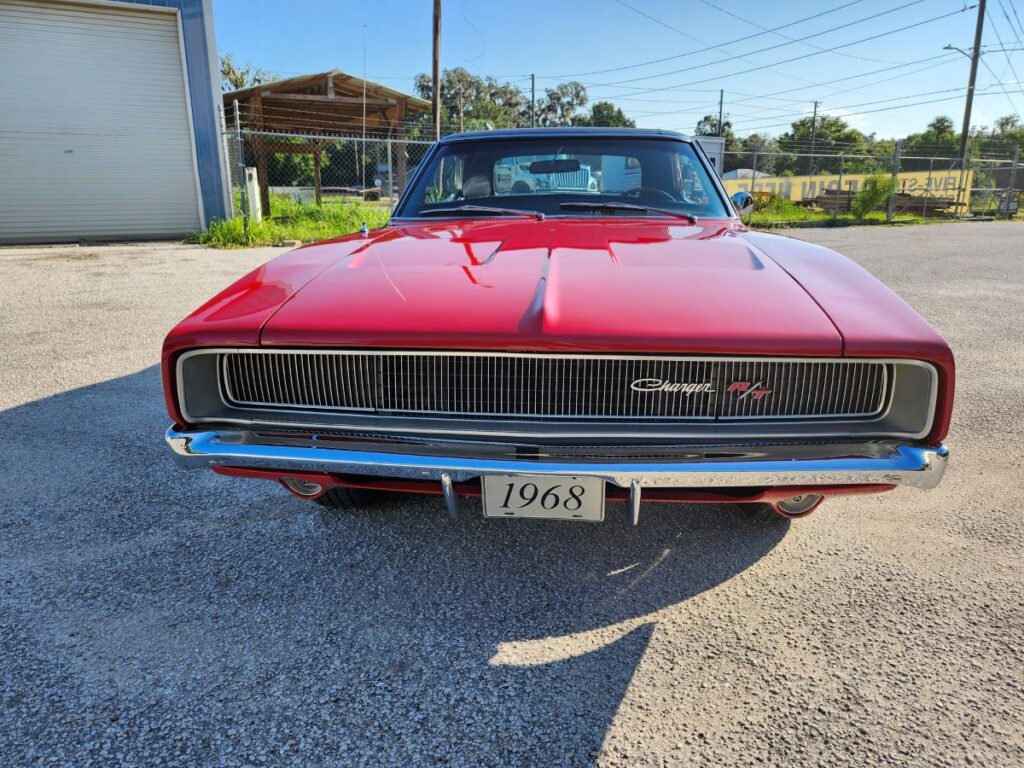 Red 1968 Dodge Charger muscle car front view showing chrome grille and original badging for classic car appraisal