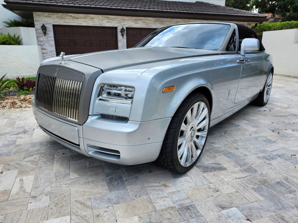 Silver 2014 Rolls-Royce Phantom luxury coupe parked in South Florida driveway for exotic car appraisal