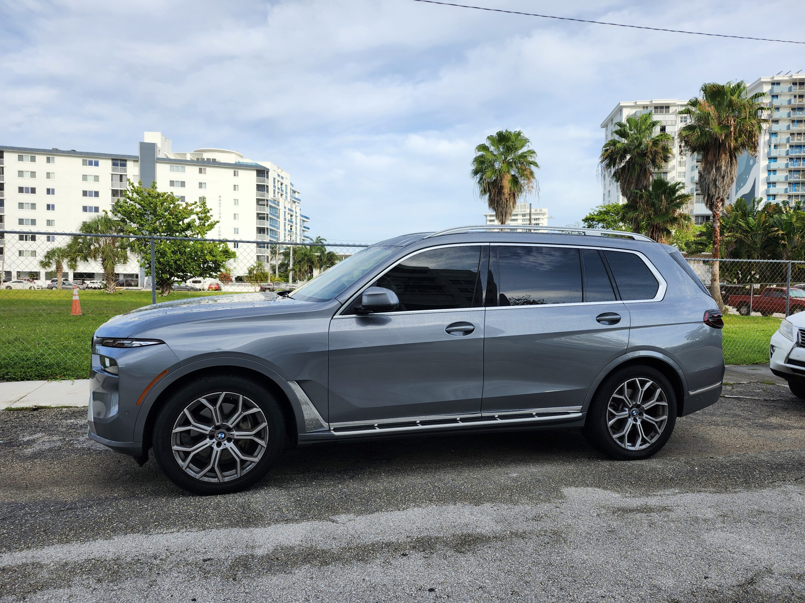 Gray BMW X7 full-size luxury SUV side profile photographed in Fort Lauderdale for total loss appraisal