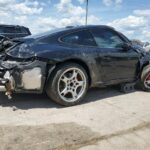 Porsche 911 coupe with severe front and rear collision damage assessed for total loss appraisal in Fort Lauderdale