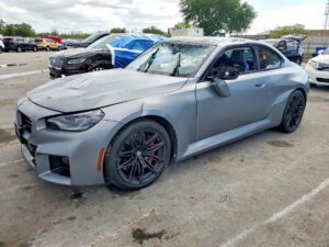 2024 BMW M2 coupe with front-end damage and shattered windshield assessed in Jacksonville for total loss appraisal.