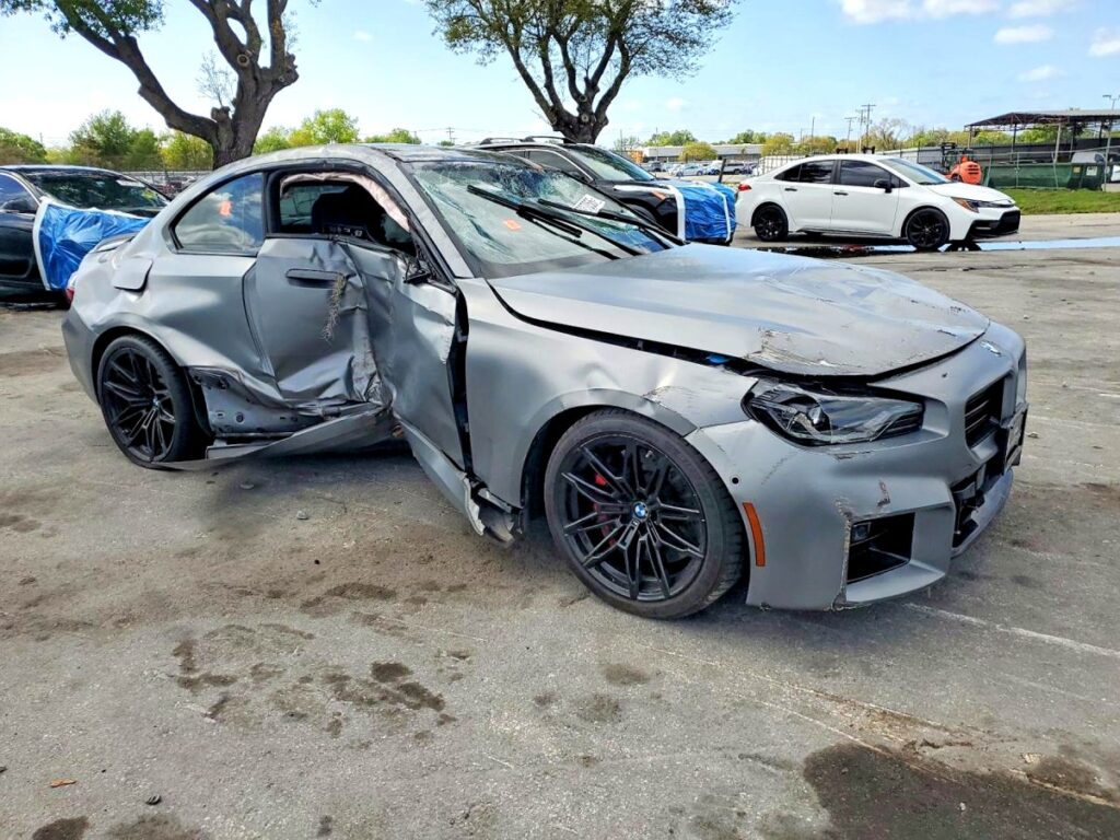 BMW M2 coupe with severe driver side and front-end collision damage at Jacksonville assessed for total loss appraisal